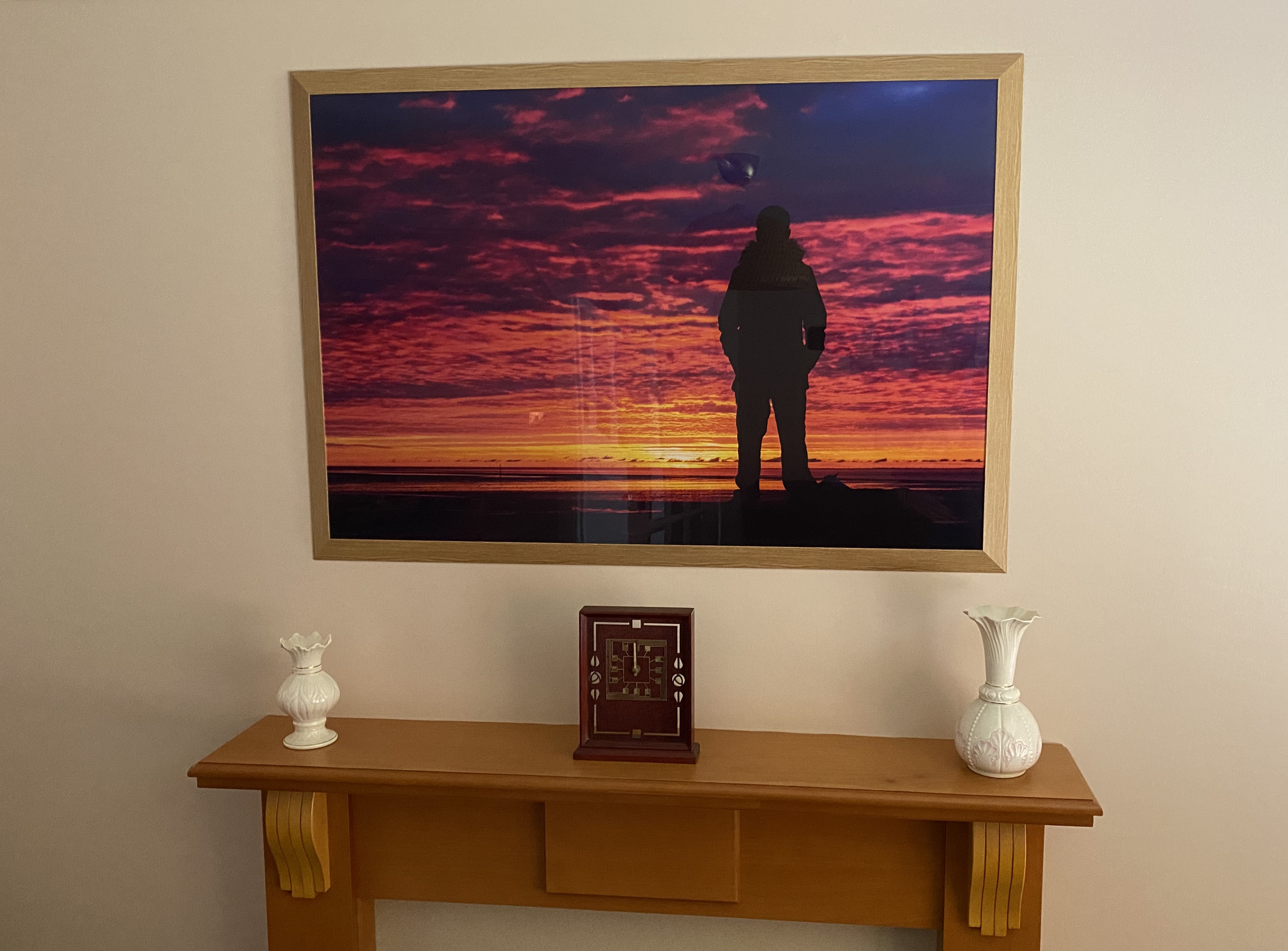 Perspective hanging above a mantelpiece - a glossy image of a silhouette on the sunset.